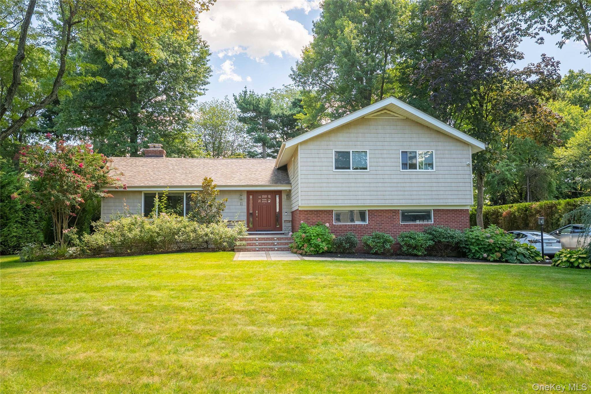 Located in the exclusive Lake Success community, this spacious split level home sits on a beautiful half acre property.