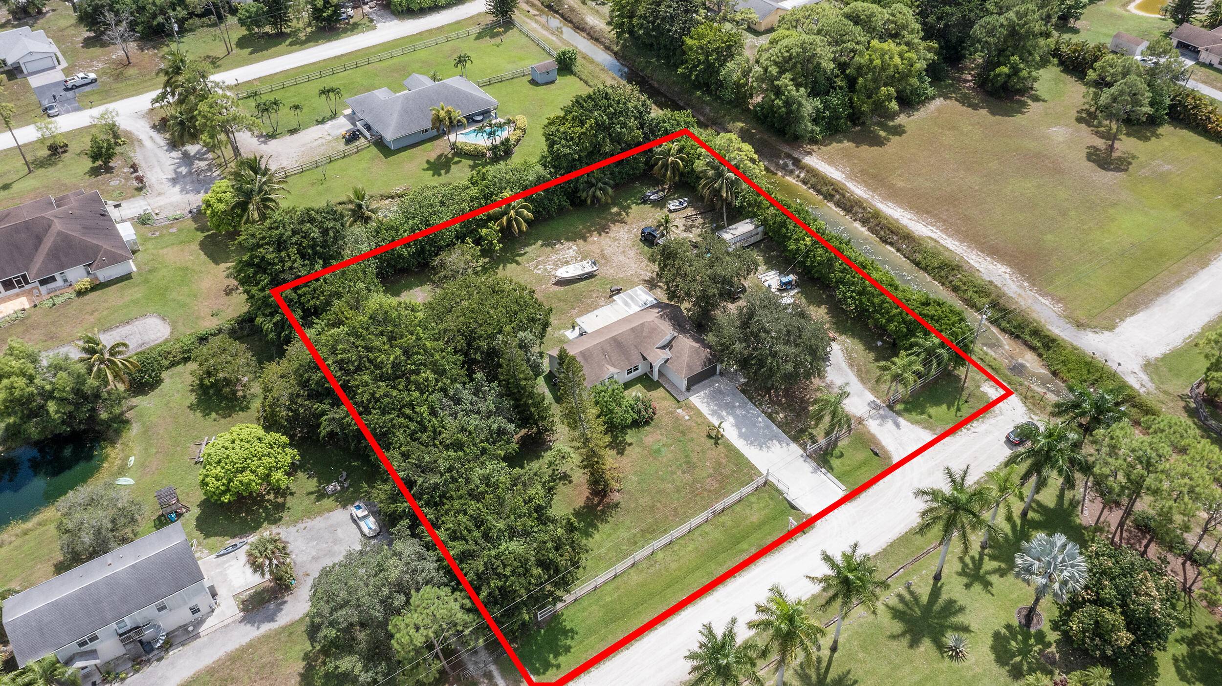 Welcome to your private retreat, 13254 79th Court N, in The Acreage !
