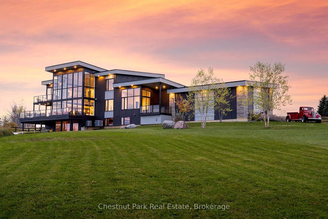 Architectural glass, steel, and panoramic views define this modern masterpiece overlooking the village of Creemore.