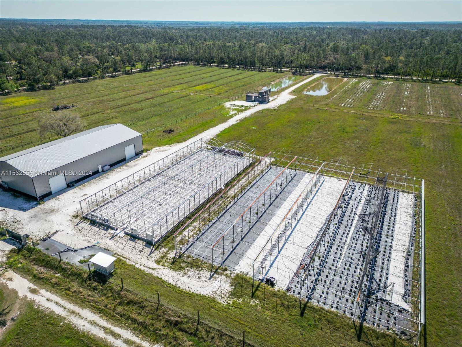 20. 15 acres zoned open use agriculture, completely fenced and gated, on a gated road, with a 7, 986 steel warehouse with 3 roll up bay doors and heavy duty ...
