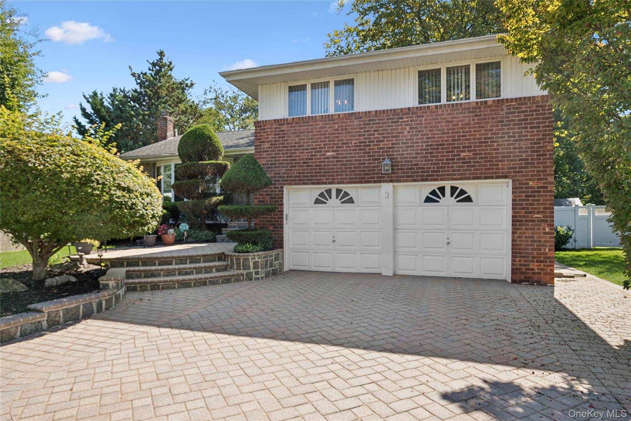 Beautifully Expanded Four Bedroom Split in the Heart of Woodbury Hills with room for extended family.