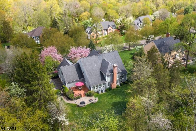 Sun filled and east facing, this distinguished brick and clapboard Colonial with hardwood flooring on first and second level, sits on a level.