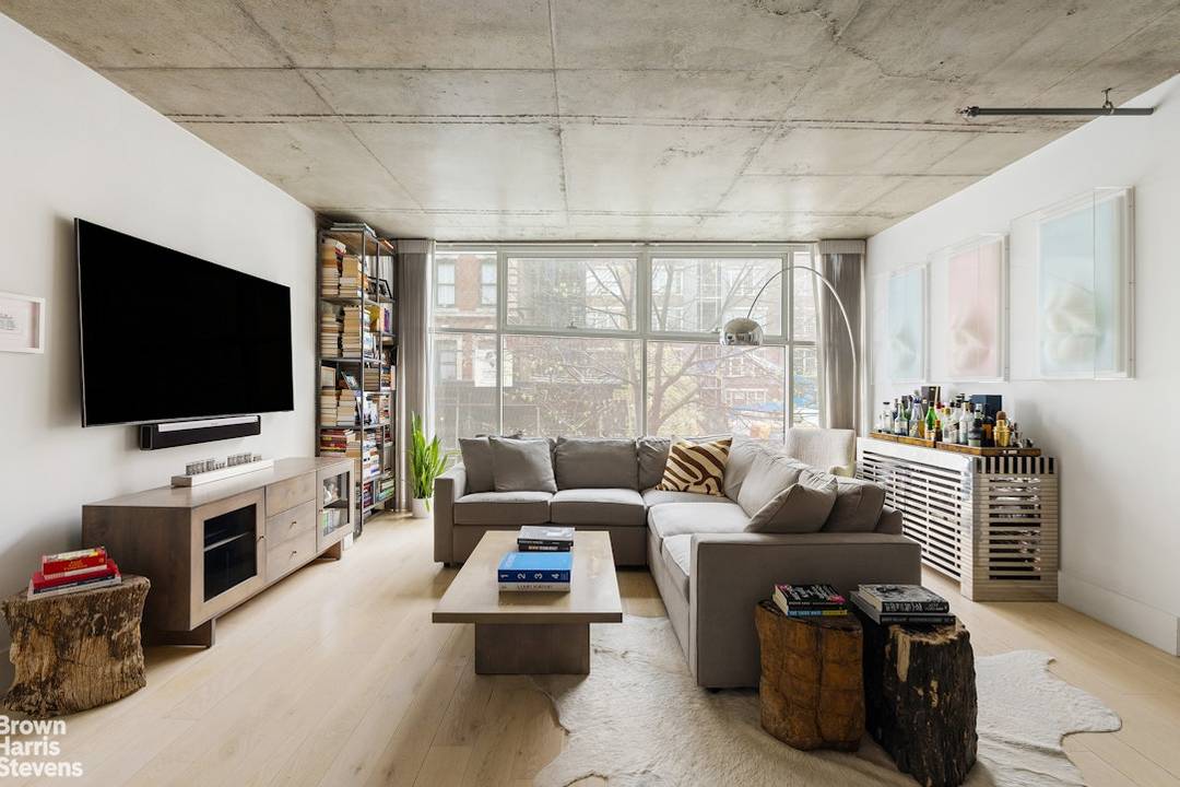 Industrially inspired, Unit 204 is a loft like two bedroom two bathroom condominium featuring a floor to ceiling glass window wall.