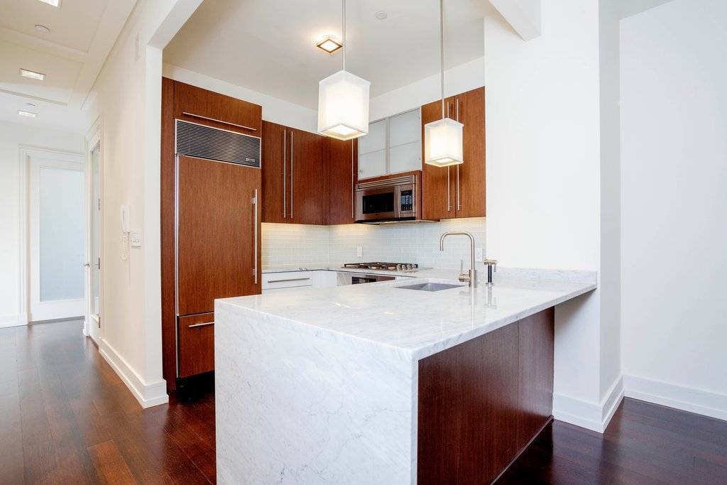 This massive studio home office features an in home Miele washer dryer, renovated kitchen with Viking and Sub Zero appliances, and Italian marble countertops.