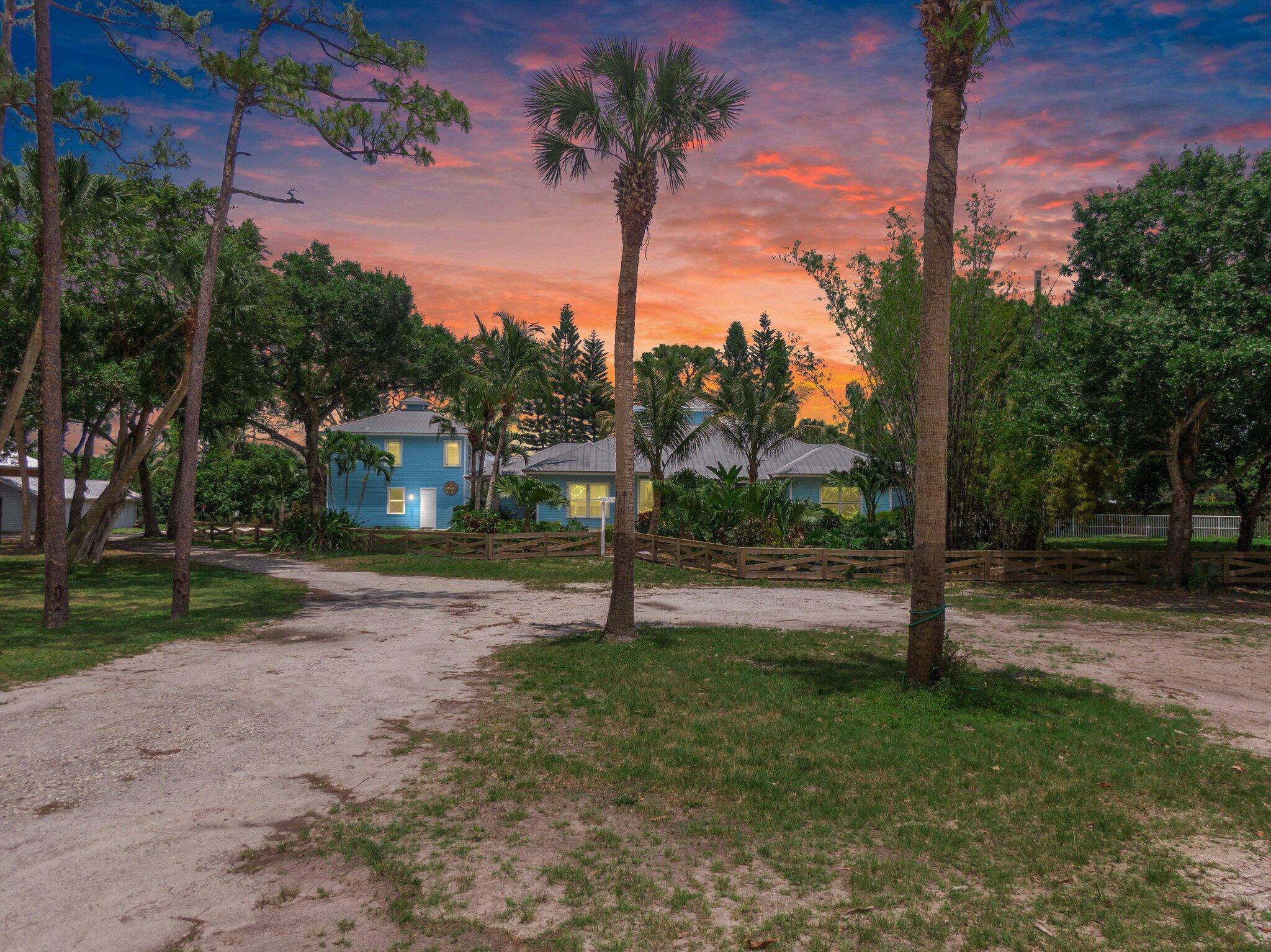 Experience timeless luxury and laid back elegance on this gated 3 acre equestrian estate in Stuart.