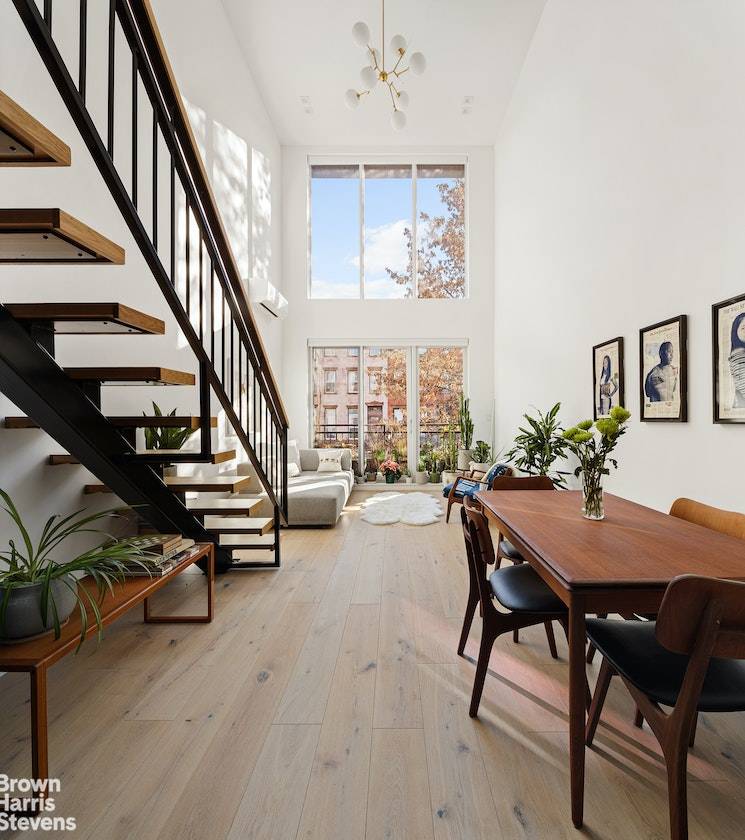 Beckon spring in this infinitely bright duplex with floor to ceiling windows, wide plank oak floors, two full bathrooms, and southern and northern exposures both with private balconies.