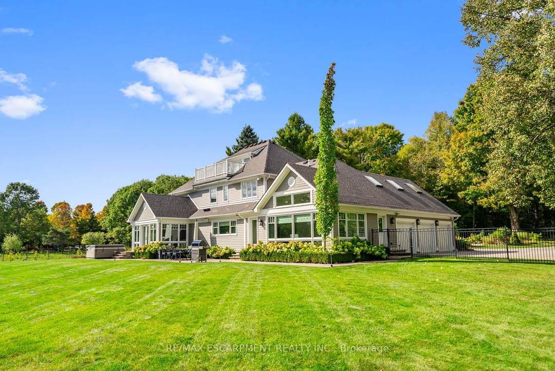 A winding driveway through the forest leads to 15 acres of private, protected land.