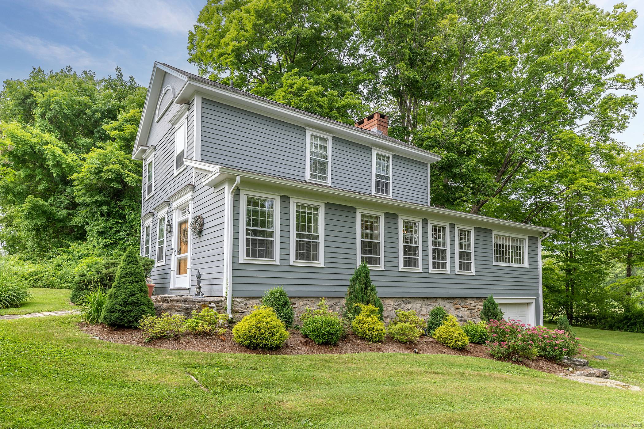 This classic side hall colonial is elegant yet charming and filled with character including gorgeous wide oak floors and a chestnut fireplace surround.