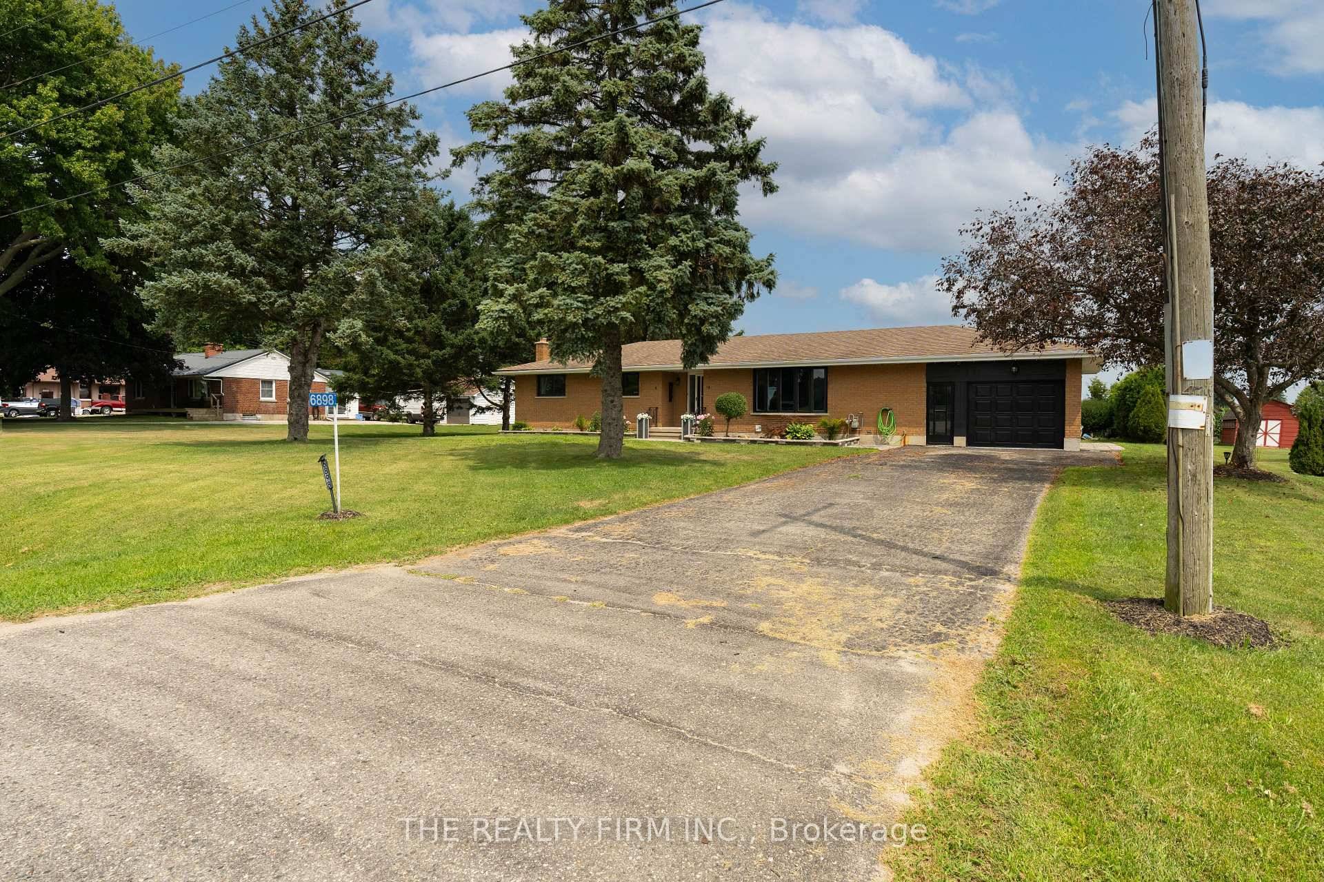 This freshly renovated and expansive ranch style home sits on a generous half acre lot, offering the best of peaceful country living while still being just minutes from St.