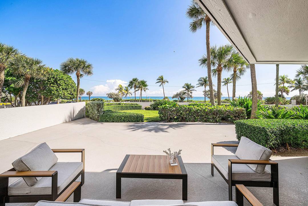Rare first floor corner residence at 120 S Ocean Blvd in Delray Beach offering direct, sweeping ocean views from an expansive oversized private terrace.