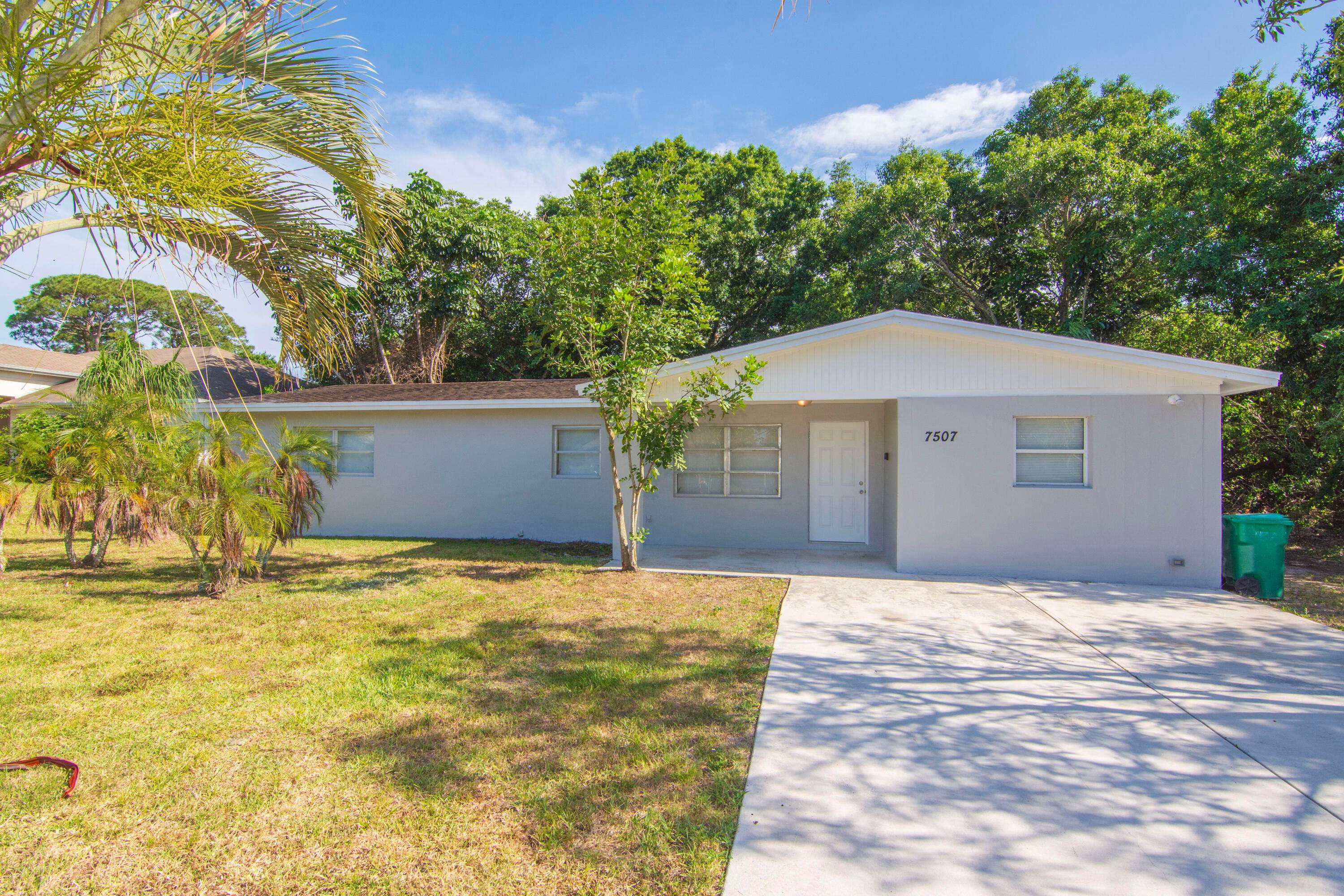 The recent garage conversion adds an extra bedroom, making it a total of three bedrooms in this freshly painted home, both inside and out.