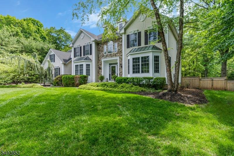Perched at the top of a private cul de sac and facing northwest, this Colonial is the epitome of luxury living, where timeless elegance meets resort style tranquility.