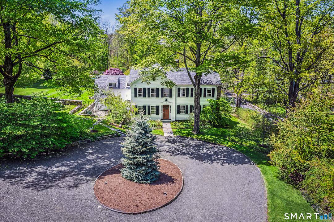 Beyond a gated entrance, this extraordinary mini estate unfolds across nearly 5 private acres in one of Ridgefield's most coveted settings.