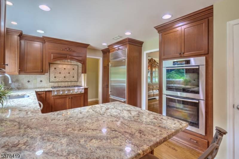 In a coveted Basking Ridge neighborhood near charming shops, schools, library, scenic trails, and local stables, this classic Colonial blends timeless design with modern comfort.