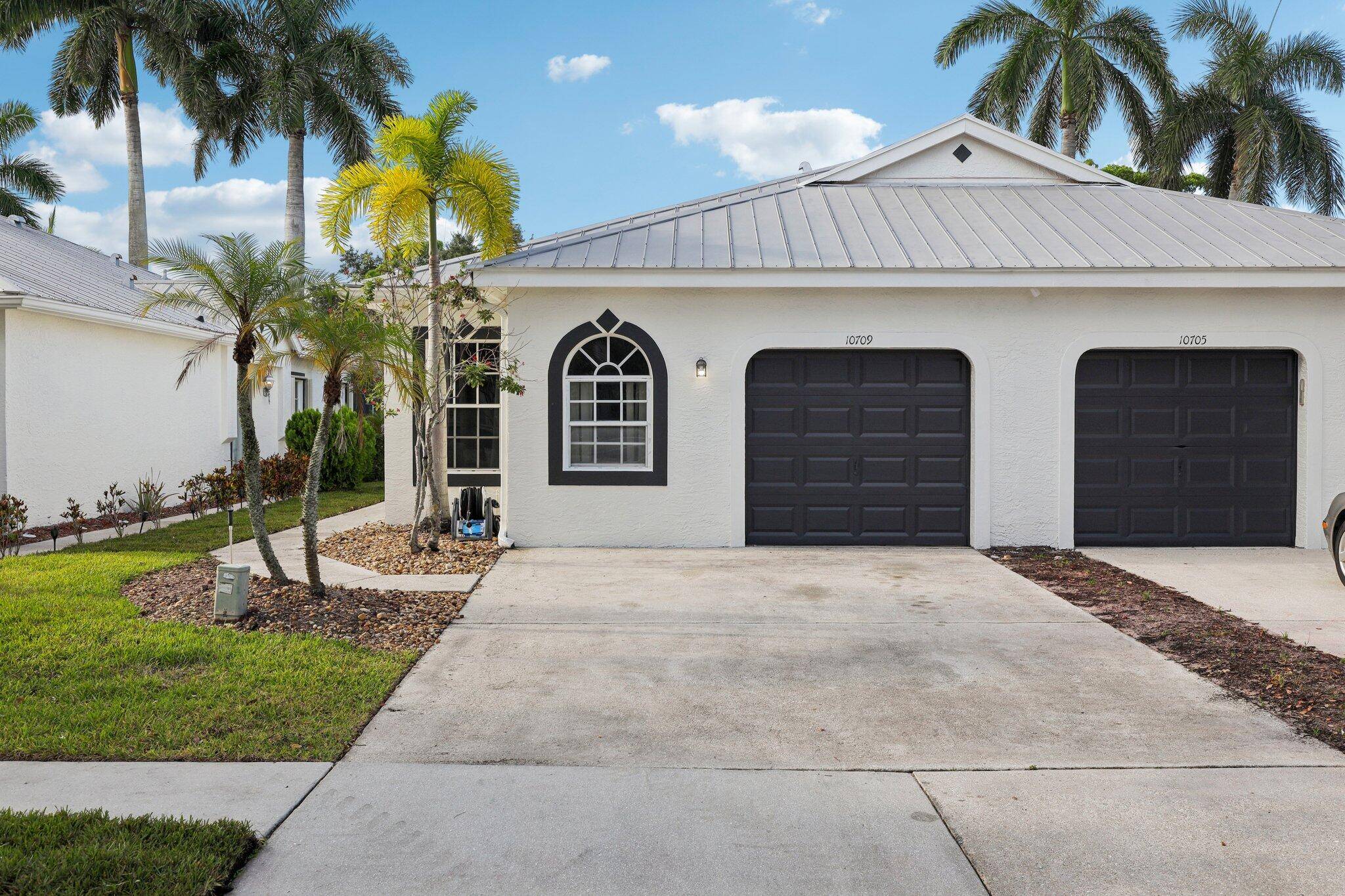 This charming villa in the sought after Pelican Key Subdivision of Wellington's Edge is nestled in the heart of Wellington with easy access to everything, including A rated schools.