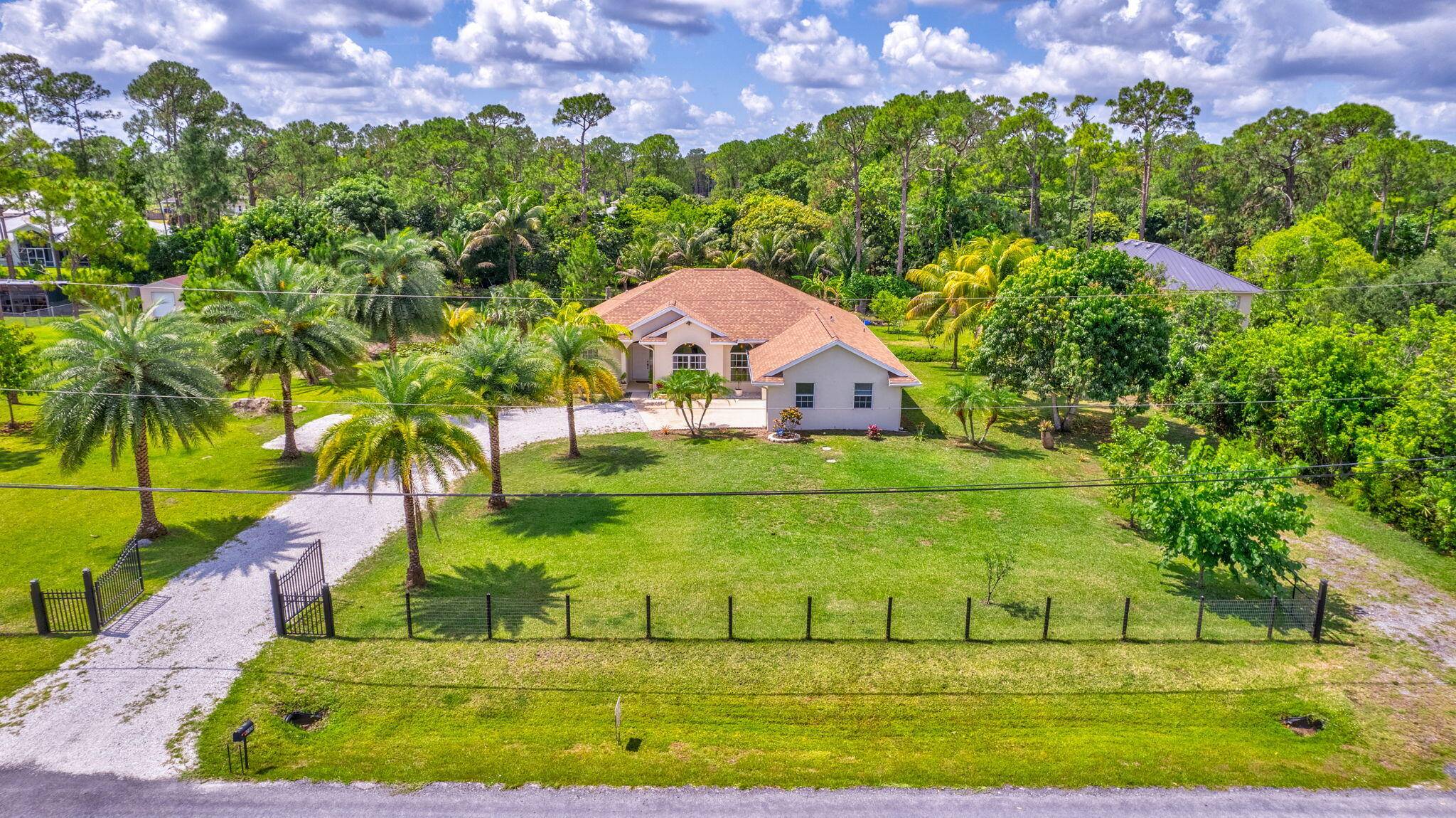Nestled on a generous 1. 15 acre lot in the serene community of The Acreage, with sylvester palm lined driveway, this beautifully maintained 3 br, 2 ba ranch style home ...