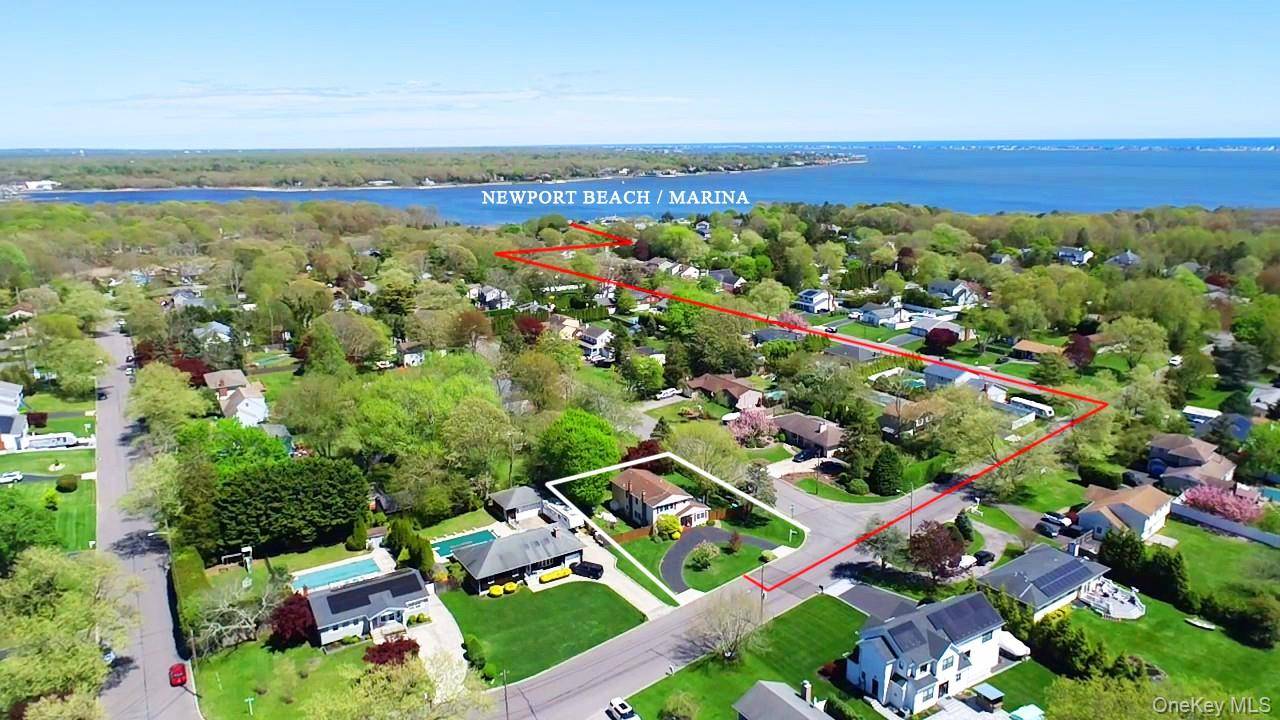 Welcome to this charming East Moriches home, just two blocks from the water, offering a serene and private setting.