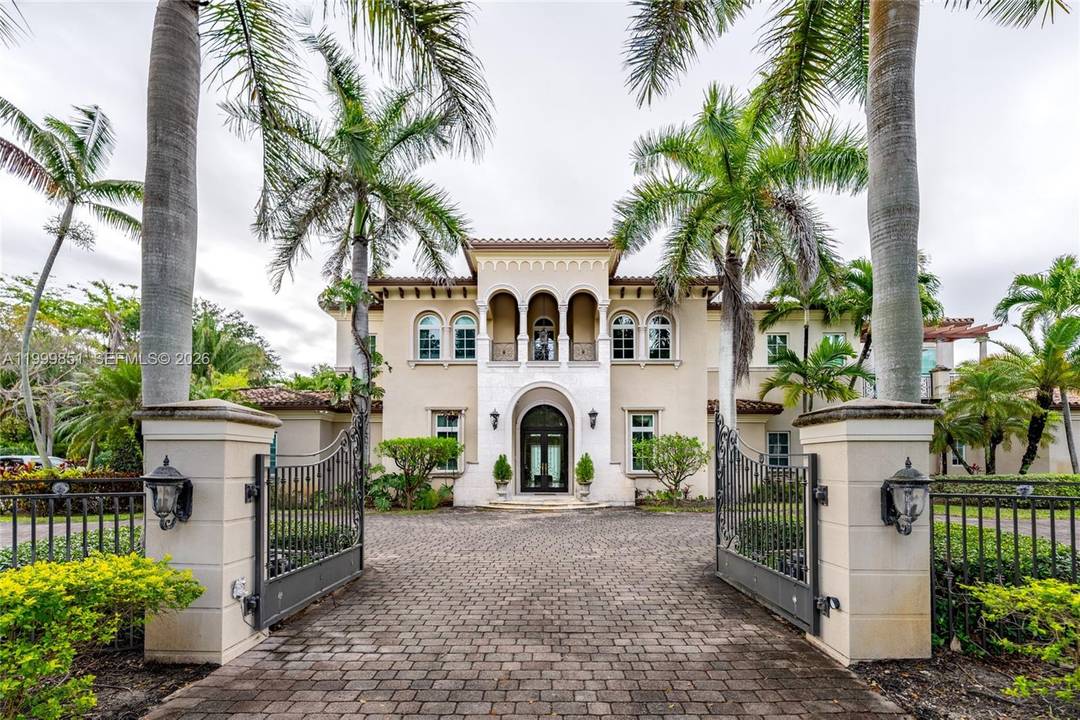 A statement of timeless elegance and architectural grandeur, this Mediterranean inspired estate welcomes you through a gated entrance framed by majestic royal palms and a sweeping circular driveway.