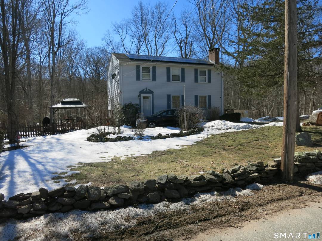 Appealing Colonial nestled on a sprawling 7 acre lot.