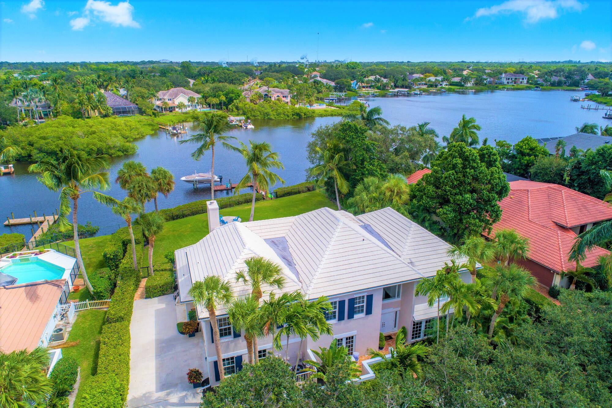 Discover this spectacular riverfront estate nestled along the North Fork of the Loxahatchee River in the prestigious gated community of Heritage Oaks.
