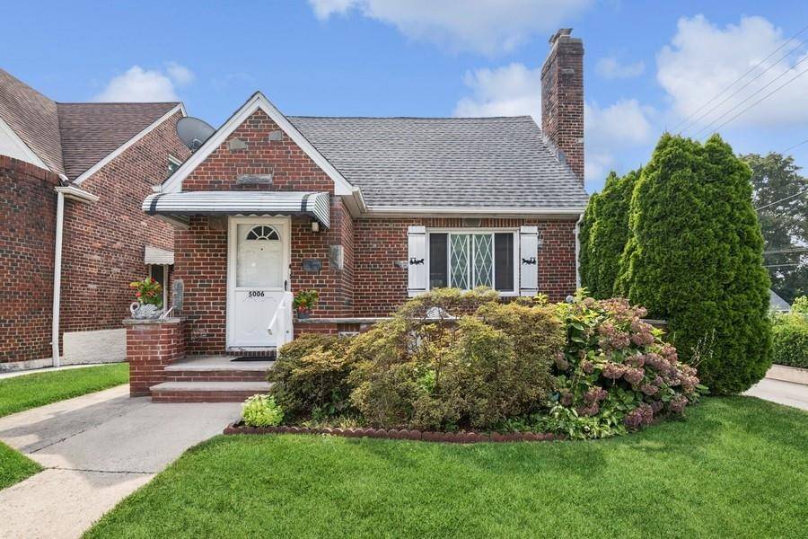 Charming All Brick Cape Cod with Front Porch and a Beautiful Backyard !