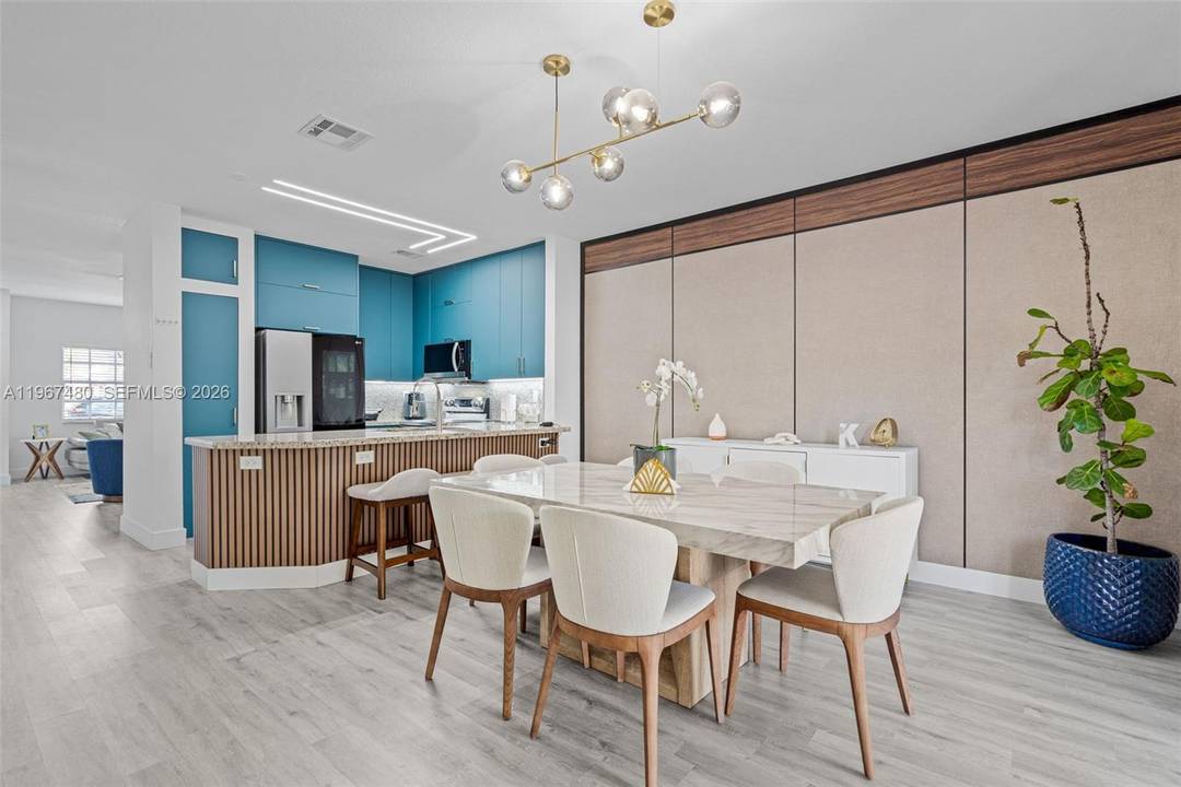 This completely remodeled corner townhome in the Las Brisas community of Doral shows like a true model home !