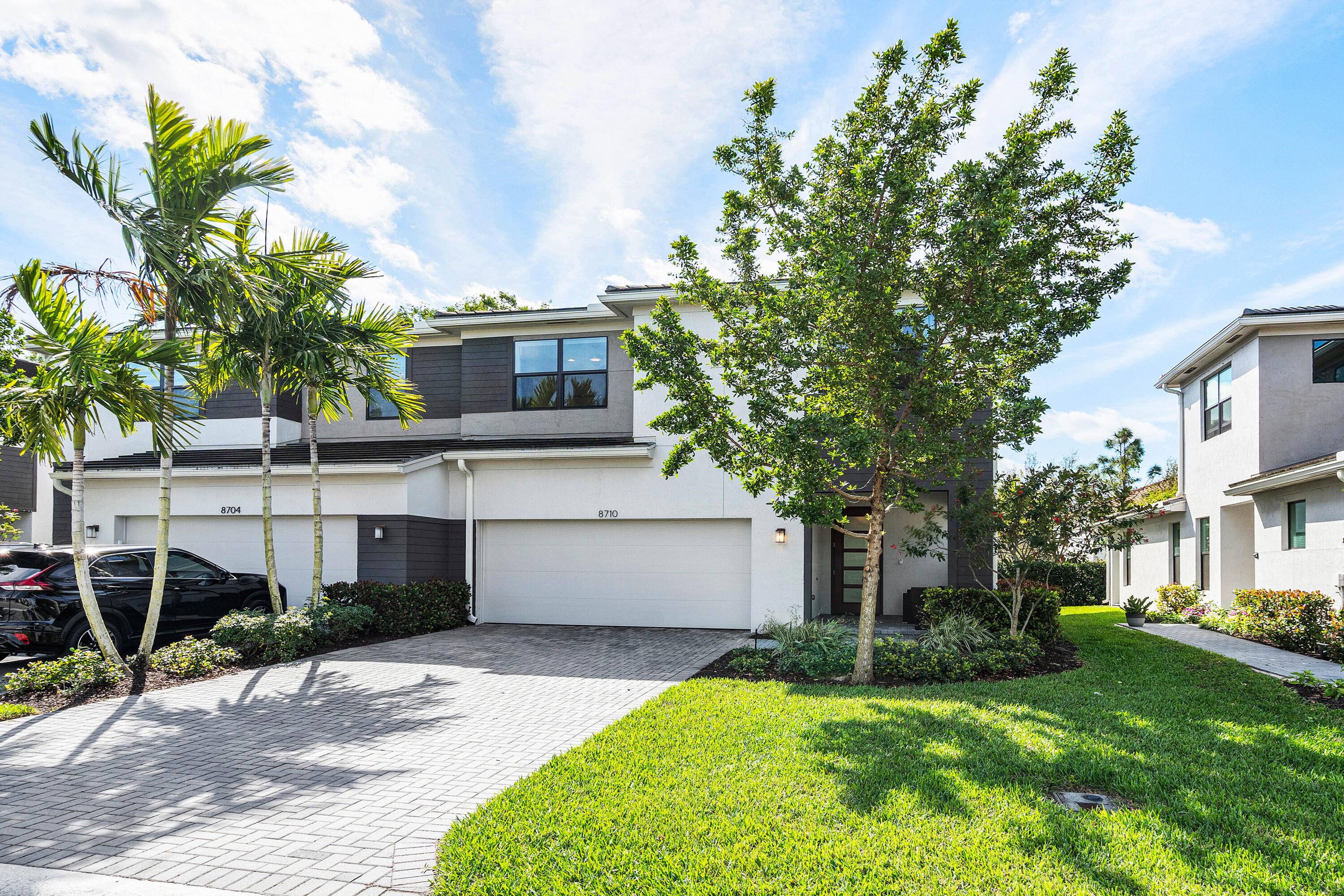 This stunning corner villa home, built in 2021 offers 2, 317 sq ft of living space, showcasing an open floor plan that is bathed in natural light from hurricane impact ...