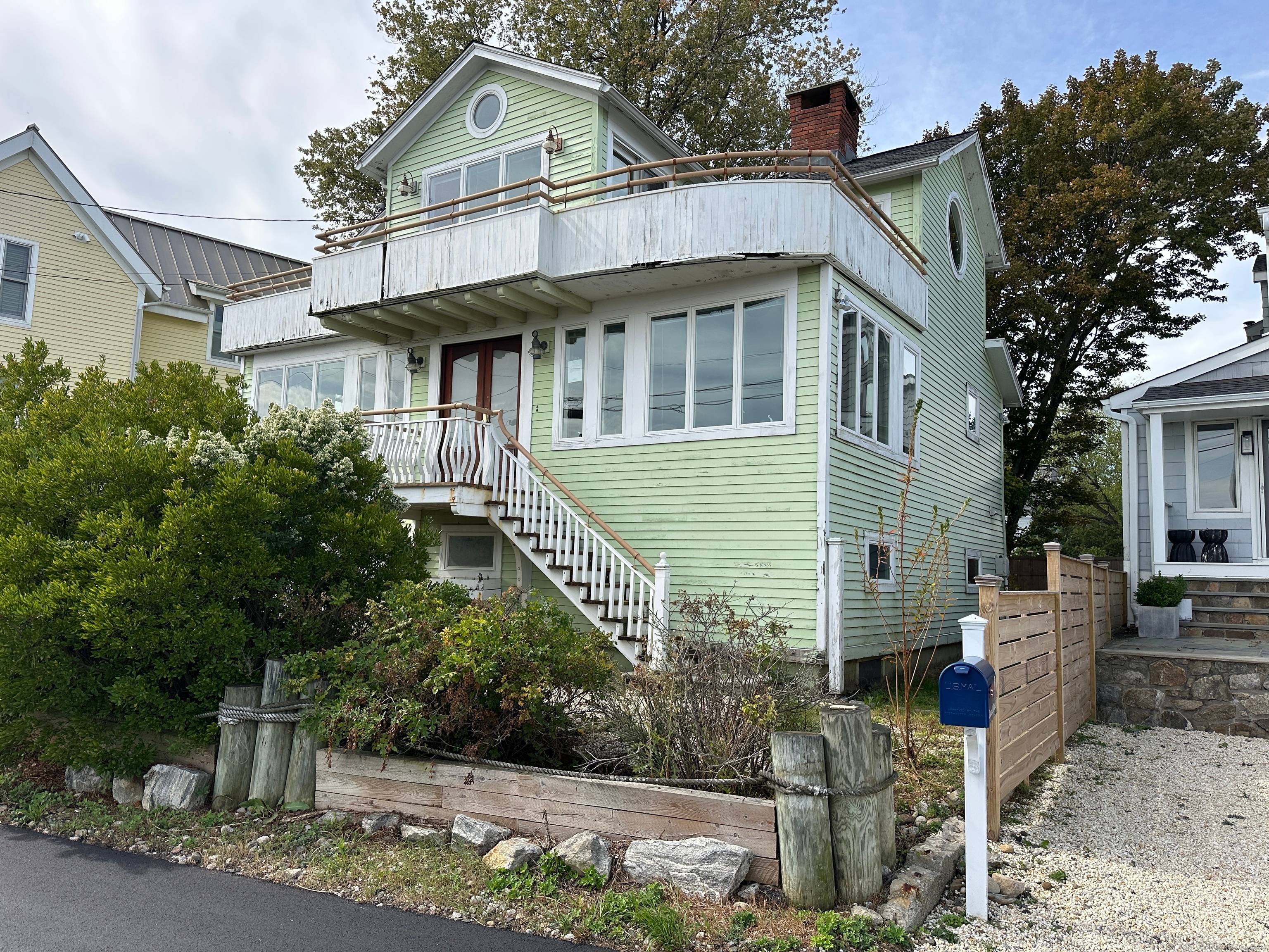 Incredible opportunity to own a coastal retreat with sweeping water views of Saugatuck Harbor and beyond.