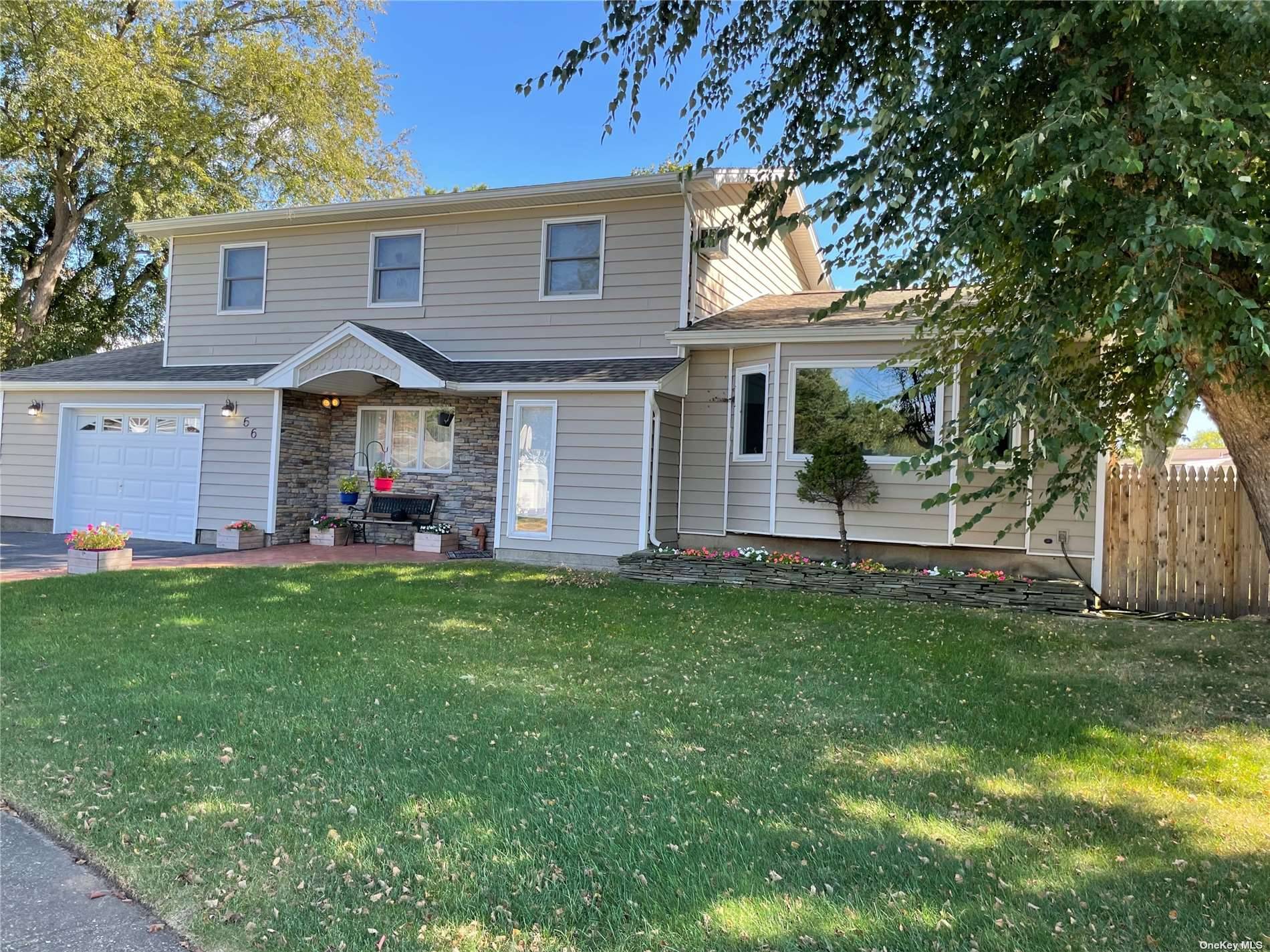 Beautifully Updated Colonial including Custom EIK W Honey Maple Cabinets and Quartz Counters.