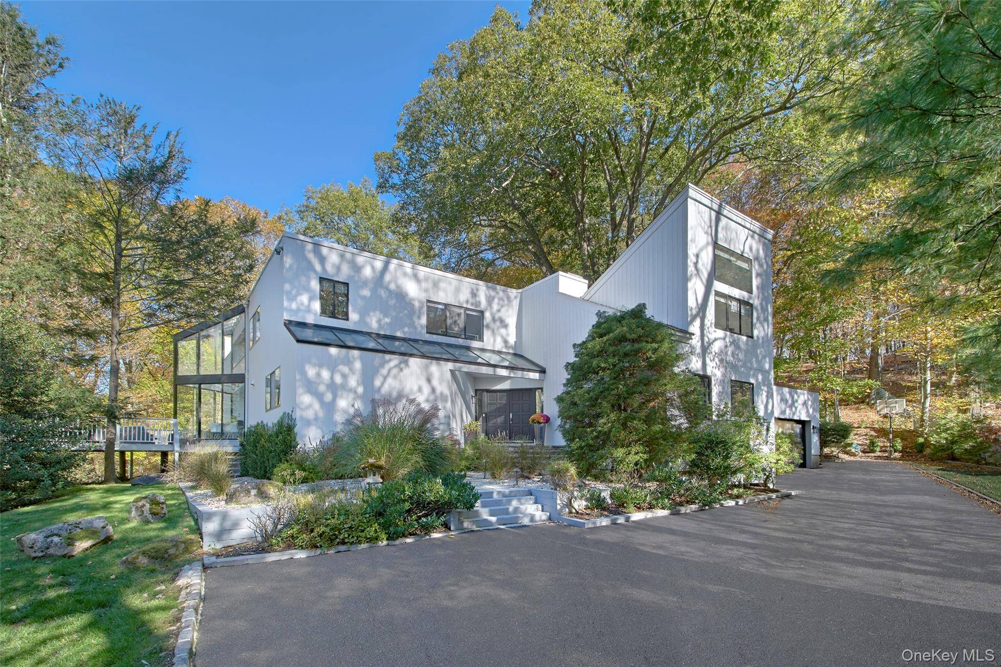 Experience modern luxury and timeless sophistication in this stunning contemporary, beautifully sited on over an acre of park like property in Chappaqua s sought after Whippoorwill neighborhood.