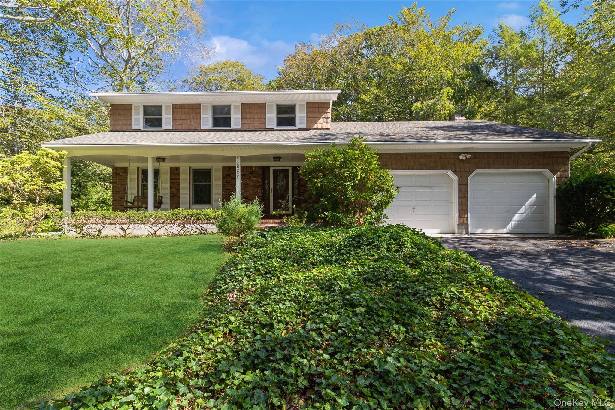 Enjoy the blissful quiet and fragrant coolness of Rolling Woods, from the covered front porch swing or rear garden patio.