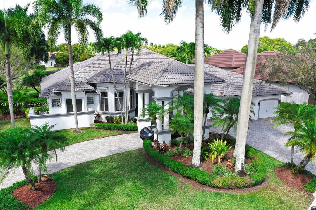 Luxury residence with panoramic golf views in Poinciana at Weston Hills.