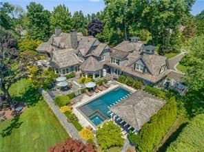 60 mins from NYC ! Set amid acres of matured specimen plantings, this New England shingle style home is a classically inspired masterpiece.