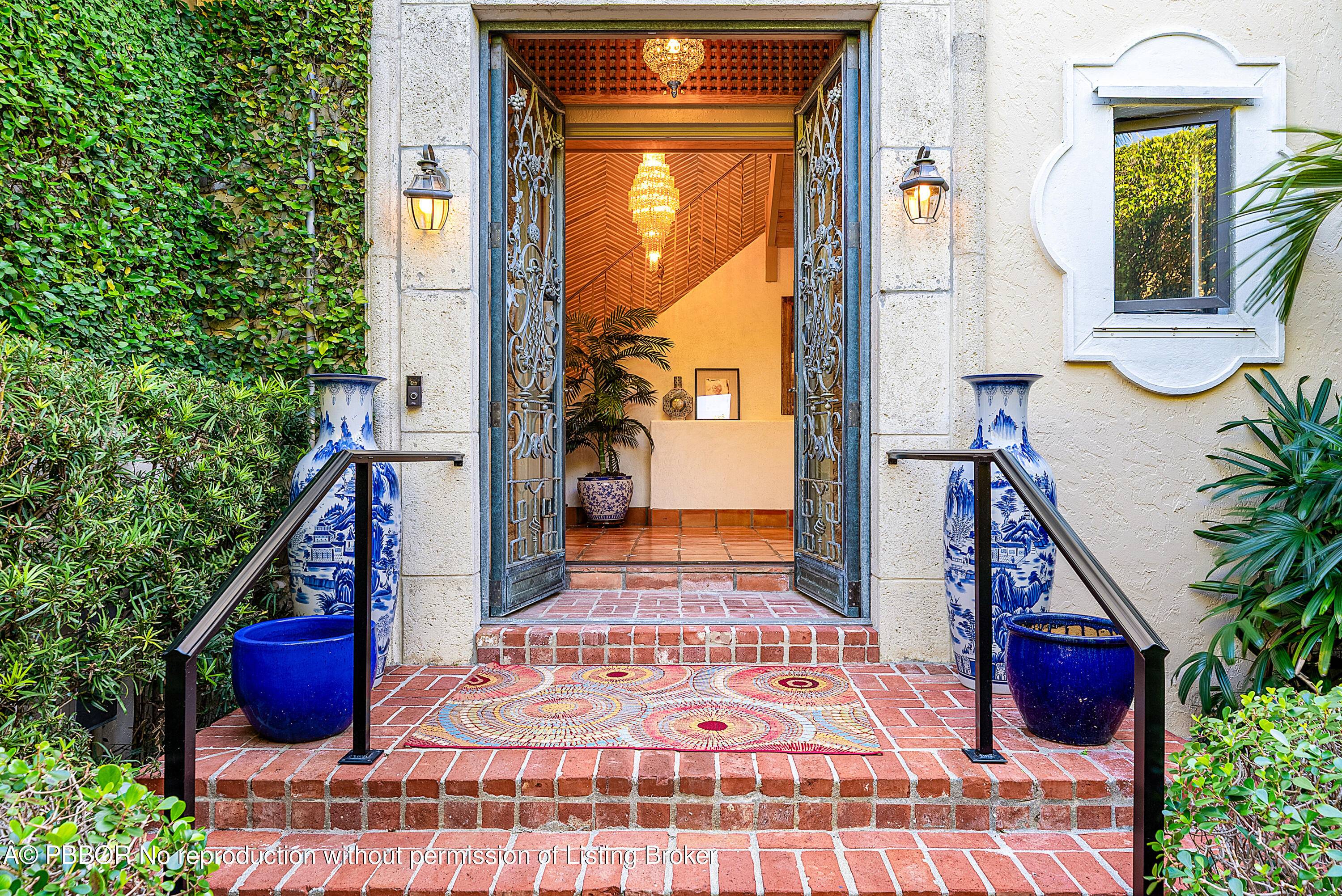 Quintessential Palm Beach living tucked behind lush hedges in a coveted island setting.