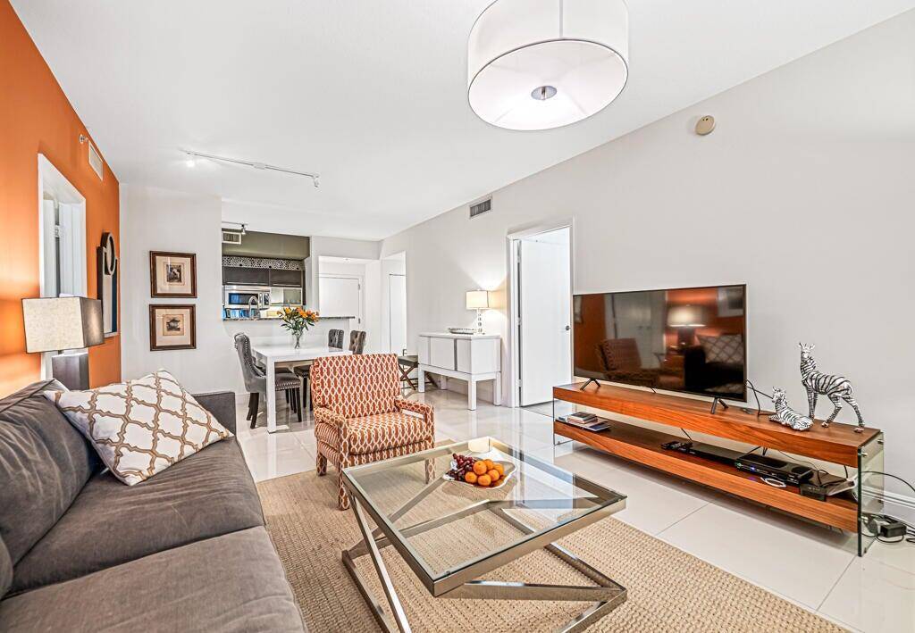 Outstanding unit featuring a rare full length outdoor patio and an additional covered balcony perfect for endless outdoor entertainment options.