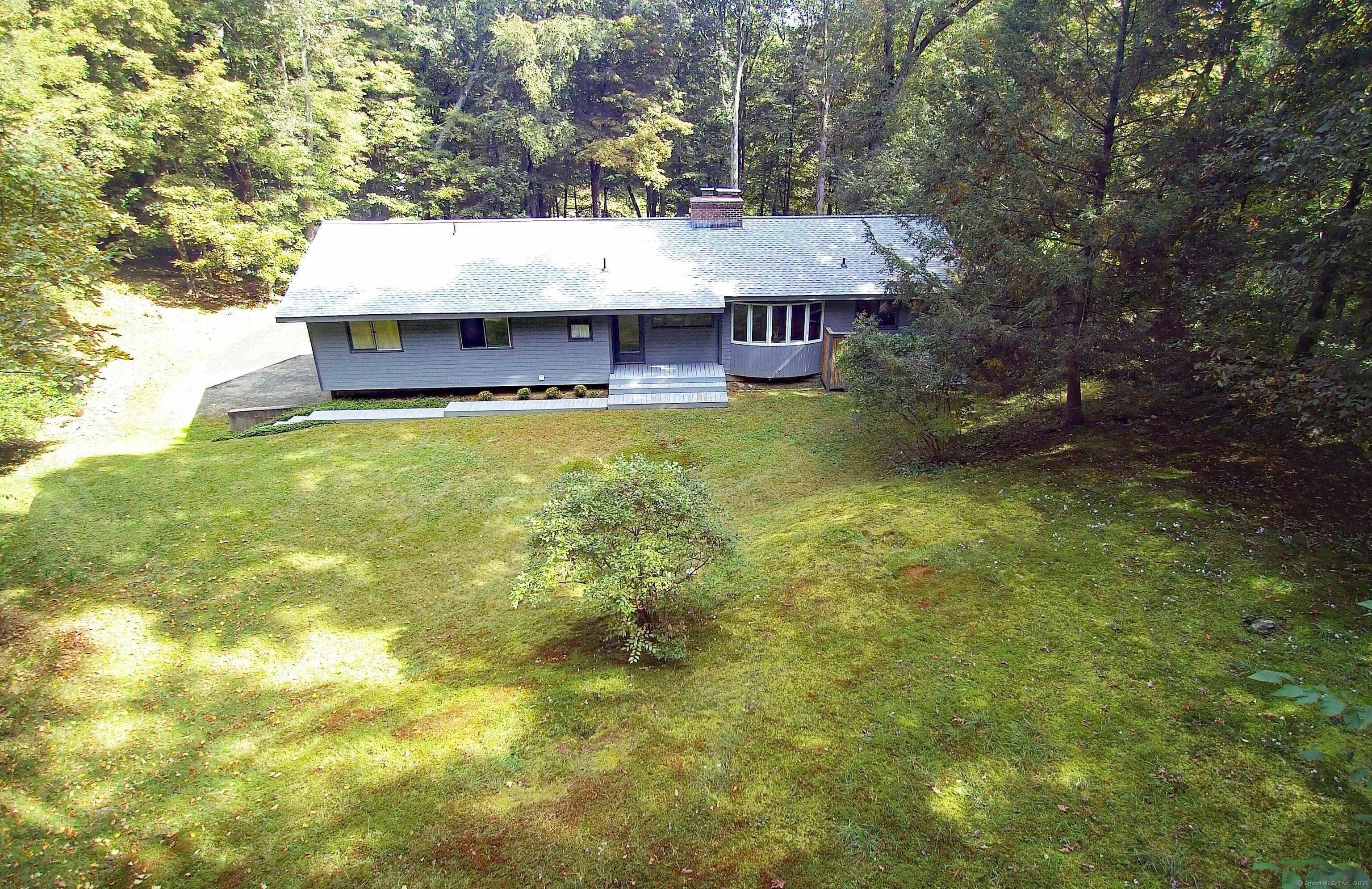 Sophisticated mid century inspired modern deck house in the sought after Umpawaug area of West Redding, set back on 4 private acres with scenic views of the neighboring pond.