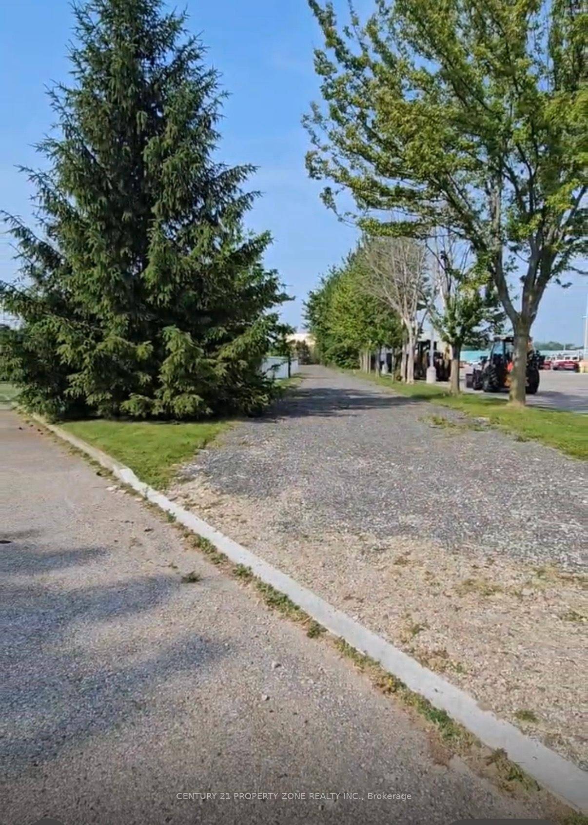 Now offering for lease a generously sized 2 acre surplus land parcel adjacent to a fully equipped industrial building, ideally suited for tractor trailer parking, outdoor storage, or equipment staging.