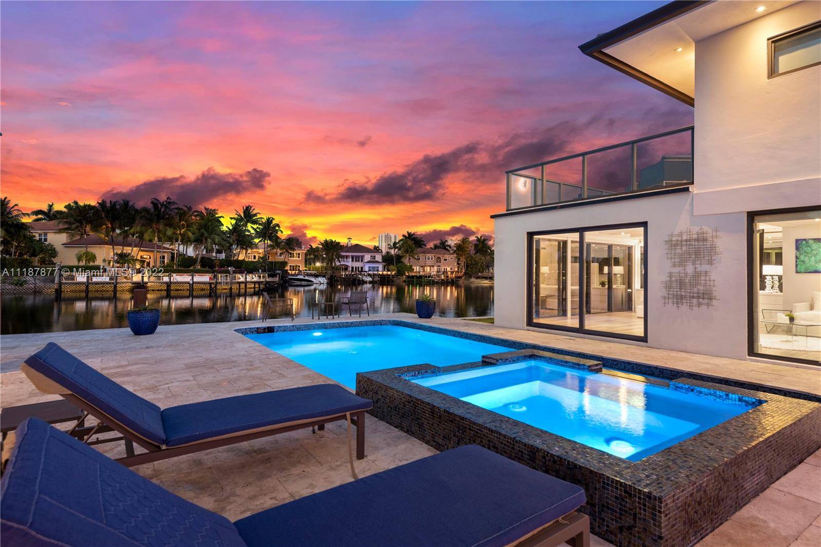 This stunning, modern waterfront mansion overlooks a wide water frontage of 90 feet views and features a private dock with boat lift.
