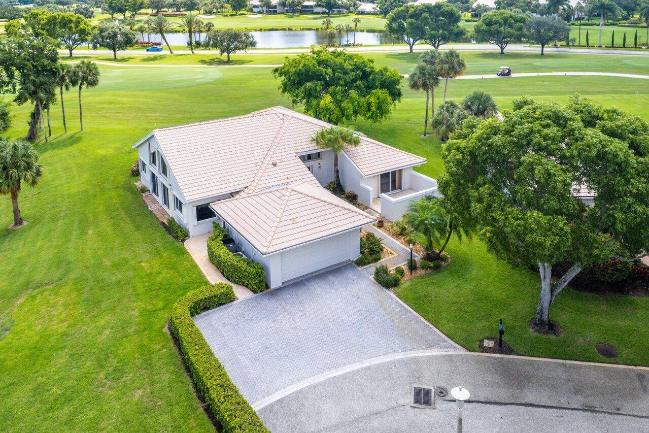 Nestled on the private corner lot of a quiet cul de sac, this 3700sf estate home captivates with panoramic golf and water views at every turn.