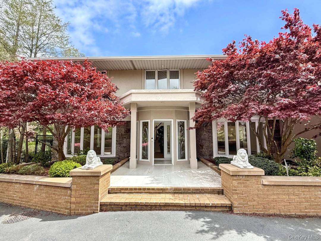 Welcome to your dream home an exquisitely renovated Colonial style residence nestled on a lush, private acre in one of Dix Hills most sought after neighborhoods.
