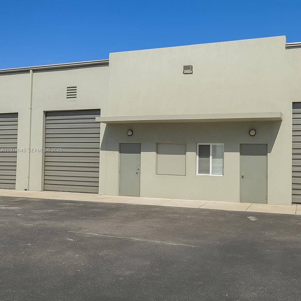 Well maintained industrial warehouse featuring A C, private office area, high ceilings, and flexible open space suitable for light manufacturing, contractors, storage, or business operations.