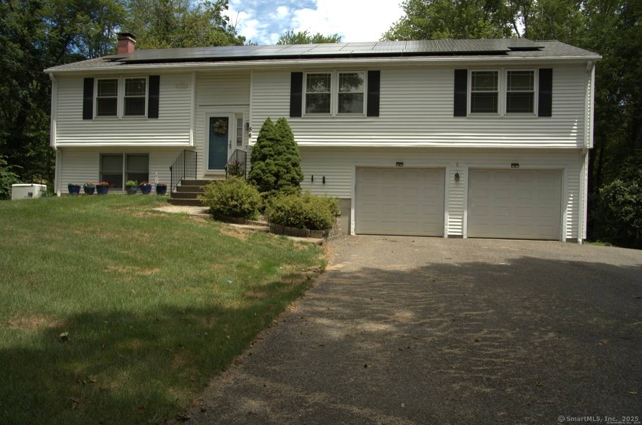Welcome to this beautifully maintained raised ranch, perfectly situated on over an acre in the serene Great Hill neighborhood.