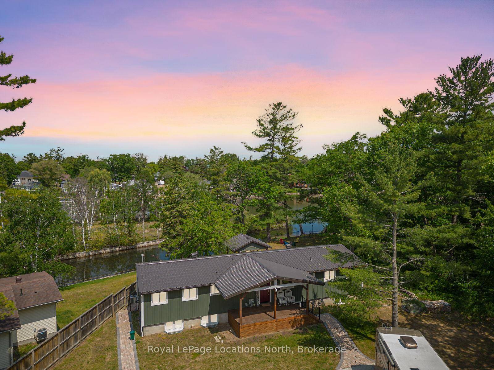 Vendor Take Back Mortgage Available Set on an Expansive Estate Lot Just Shy of an Acre, this Remarkable Property Boasts 128 feet of River Frontage One of Very Few Parcels ...