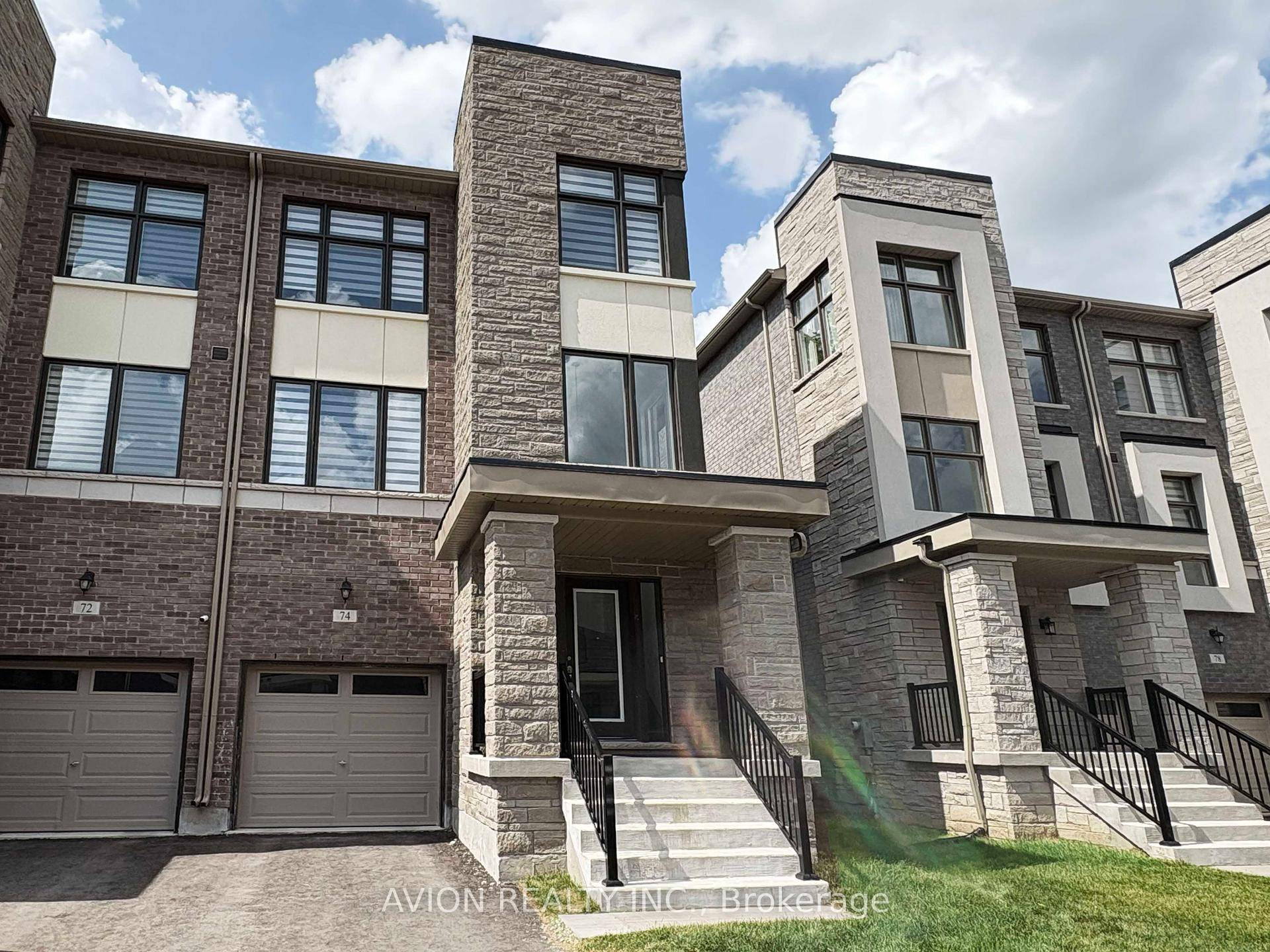 Modern open concept kitchen with breakfast area, stainless steel appliances, central island, and granite countertops.