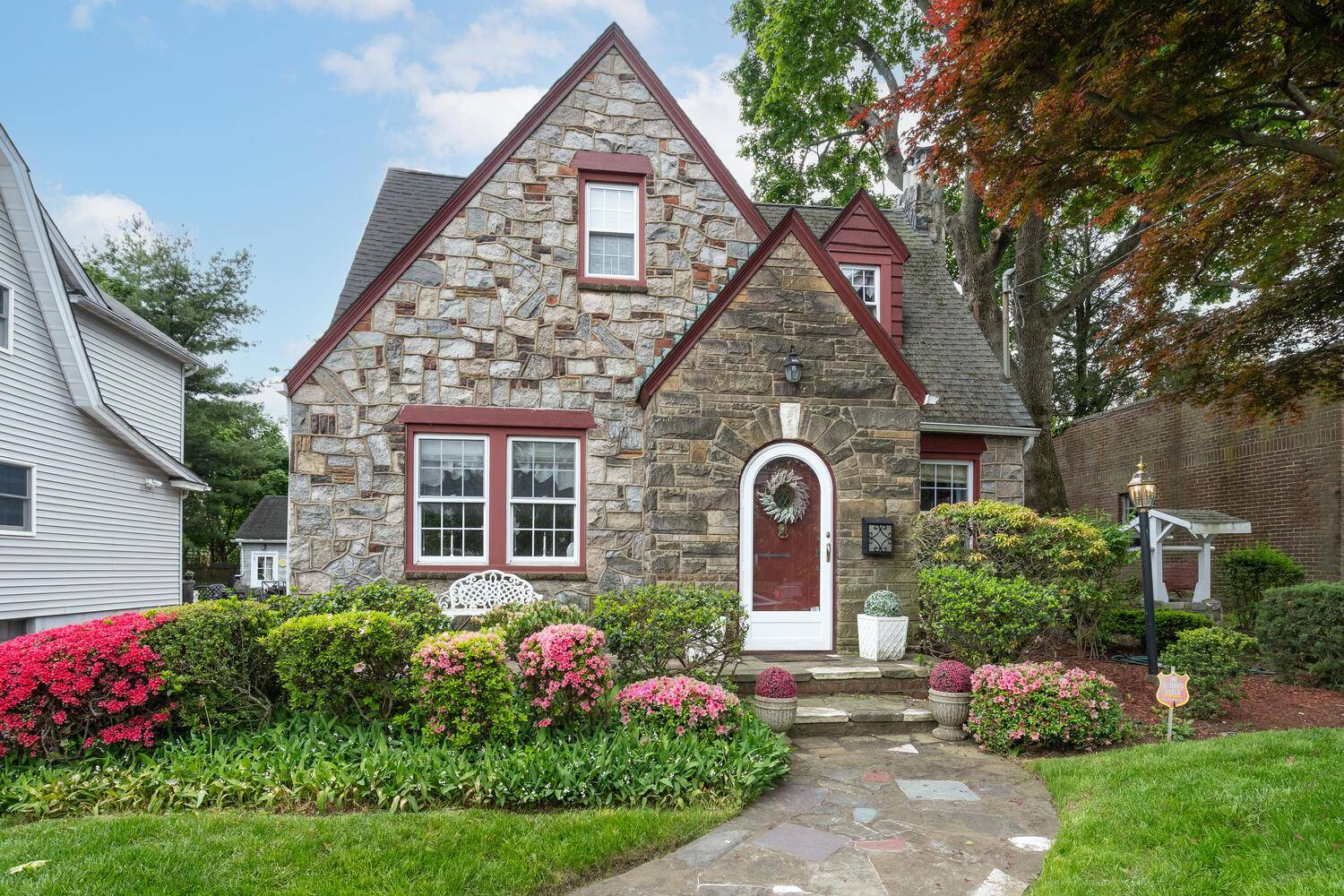 Nestled in the charming village of Williston Park, this inviting colonial boasts beautiful stone and brick exterior.