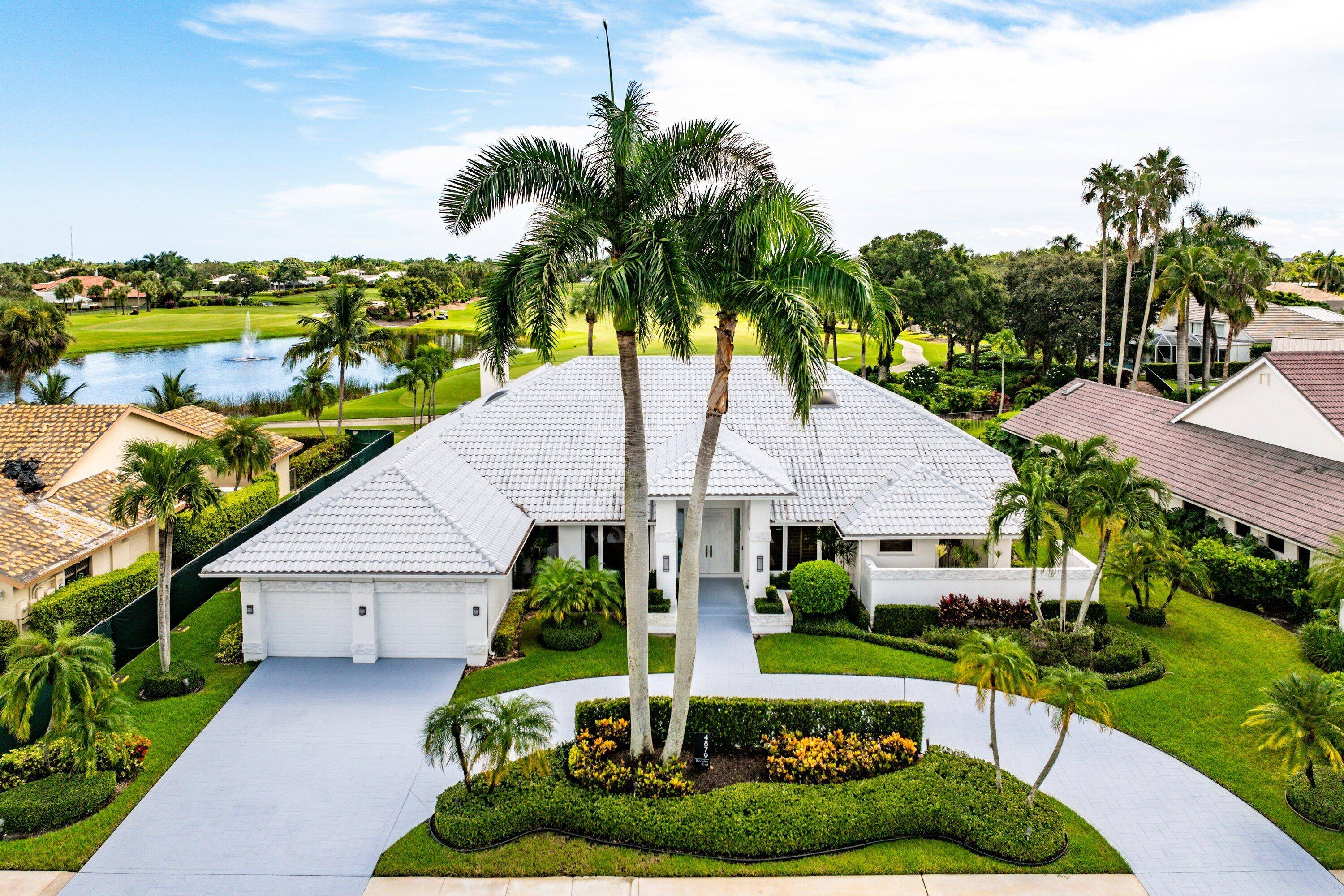 World class golf welcomes you to this sprawling one story custom residence in Bocaire CC.