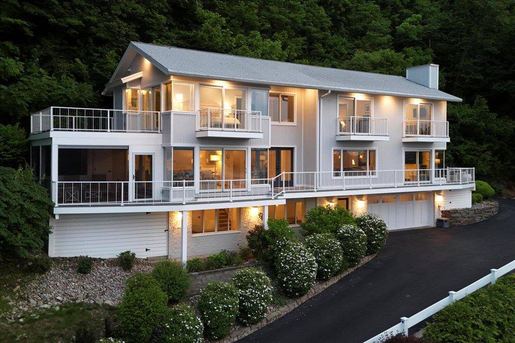 Presenting an exquisite contemporary residence on Balmville's prestigious River Road, offering unparalleled views of the Hudson River, the majestic mountains, and the iconic Newburgh Beacon Bridge.