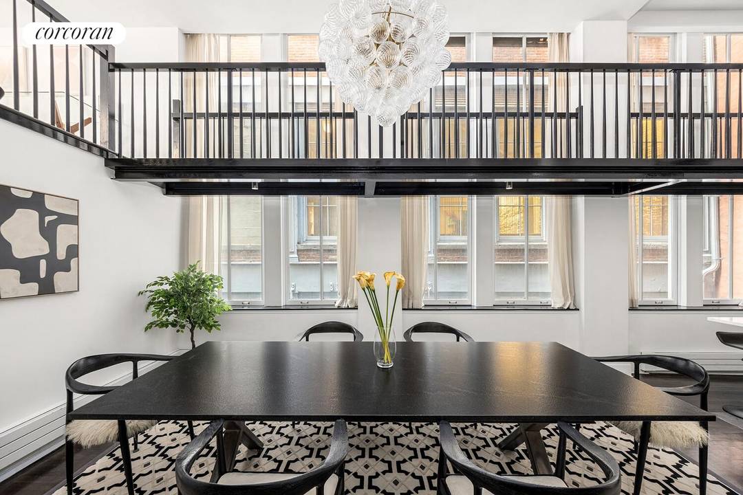 Nestled in the heart of Tribeca, this exceptional triplex loft seamlessly combines historic architectural charm with a sophisticated modern design.