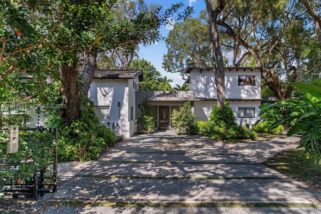 Experience a modern South Coconut Grove residence that perfectly blends luxury design, privacy, and lifestyle.