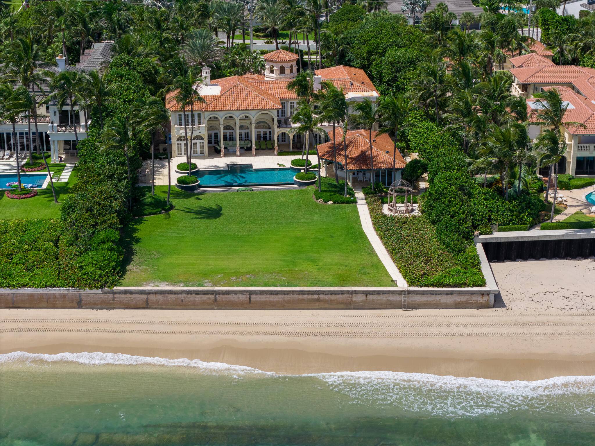 In a gorgeous tropical setting on the beach in Ocean Ridge, this elegant villa commands magnificent ocean panoramas.